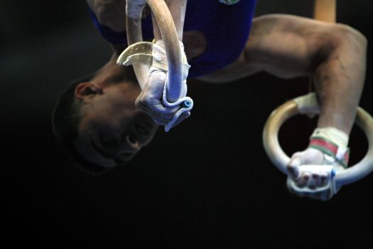 Close up of the gymnast competing on rings