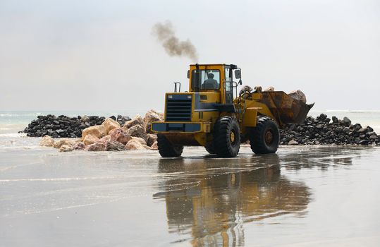 A view of a big bulldozer on coastline