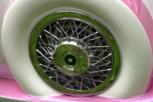 Wheel of the automobile with green reflection