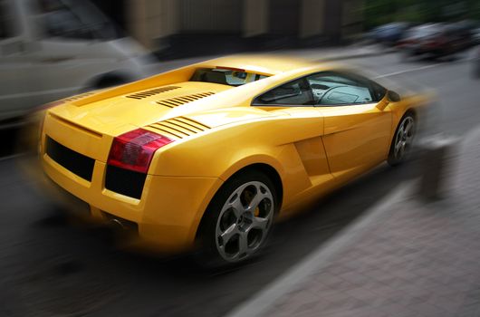 The image of the yellow respectable automobile on a dim background