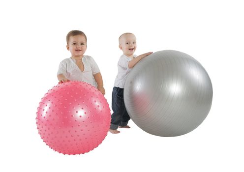 An isolated photo of two boys with fitness balls