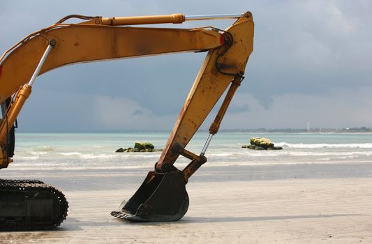 A view of a big bulldozer on coastline