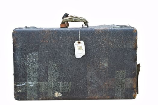 Vintage suitcase with old airline tag isolated on a white background.