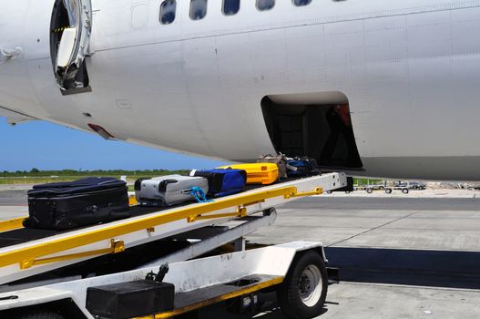 Jet airliner on the ramp loading / offloading luggage