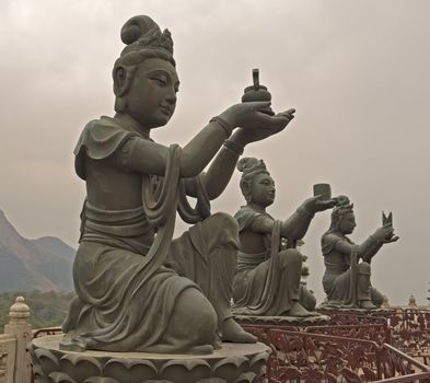 three Nirvanas monuments in front of Buddha in Hong Kong China