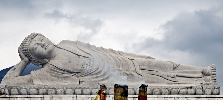 Sleeping Buddha in China cloudy sky on backround