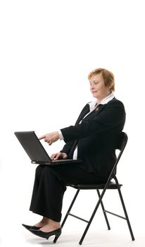 Mature businesswoman searching internet on her laptop computer