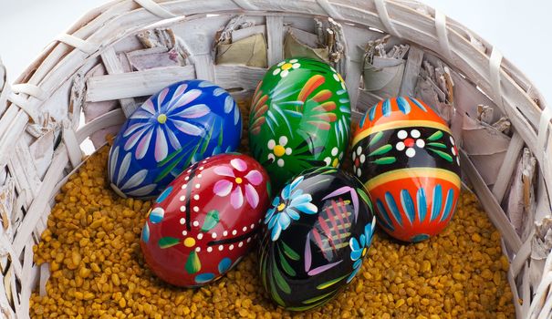 Many colorful eggs in a wicker basket