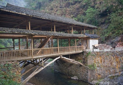 Southern China near Guilin wodden bridge over the mountain river