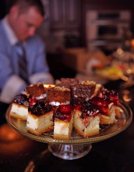 Plate of various cakes cheese cake, and chocolate cake in the kitchen