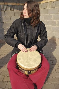 the girl playing on the drum, street musician