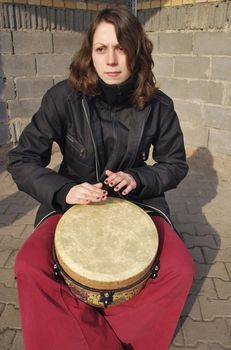 the girl playing on the drum, street musician