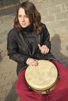 the girl playing on the drum, street musician