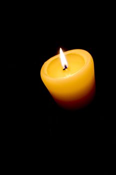 Candle light at isolated black background