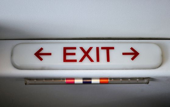 Exit sign in passengers cabin of commercial airliner