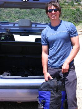 a young man on a road trip is stopping at the beach