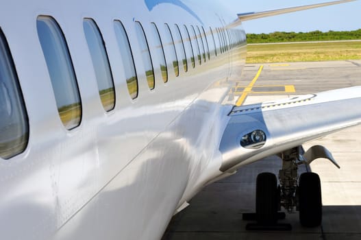 Air transportation: passenger jet fuselage and wing detail.