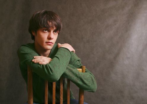 Portrait of the young in studio. Hands are crossed on shoulders