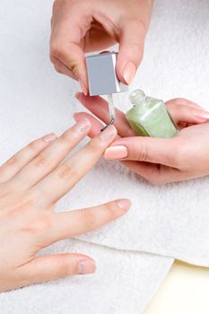 applying manicure: moisturizing the nails and skin around nails