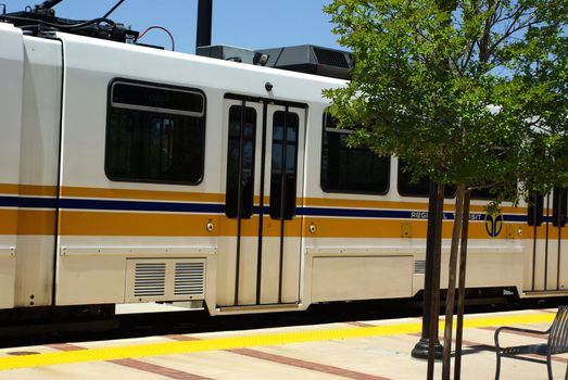 Local light rail train pulling up to the train station.