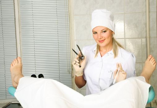 portrait of a young gynecologist examining a patient in her office  