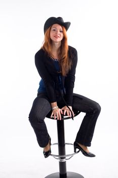 Young girl with  black hat sitting on chair on white background
