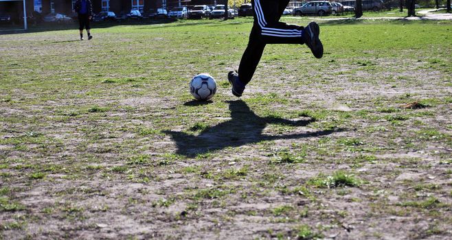 man kicks the ball