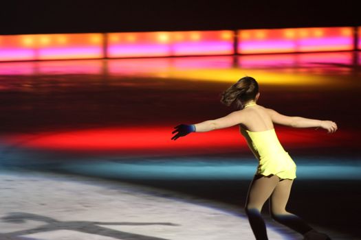 a  young girl is performing at figure skating 