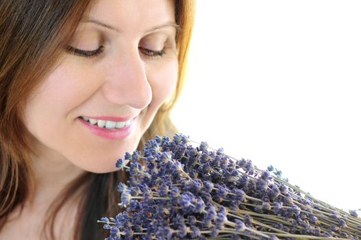 Mature woman smelling bunch of dried lavender