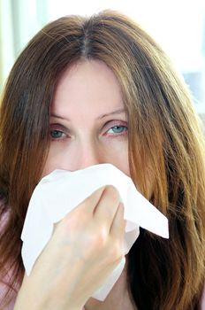 Mature woman with a flu or an allergy symptoms