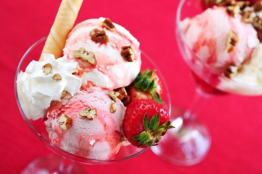 Strawberry ice cream sundae with fresh strawberries and walnuts