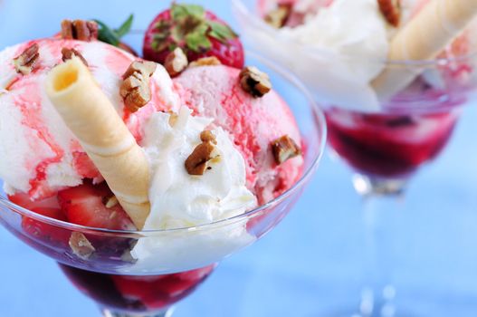 Strawberry ice cream sundae with fresh strawberries and walnuts