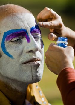 MONTEVIDEO, URUGUAY - FEBRUARY 1: A carnaval participant has his face covered with makeup prior to participating in the annual national festival of Uruguay , the main events and activities of this "fiesta" is usually made in Montevideo along with other activities in the inner towns and cities. Each year, government and citizen partnership make it sure that the Carnival will be special and unique for each and every year.

 