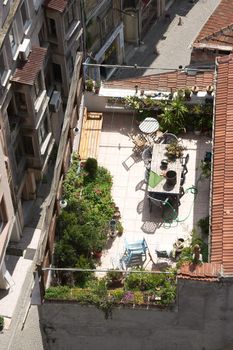 Terrace on the roof with green garden and flowers