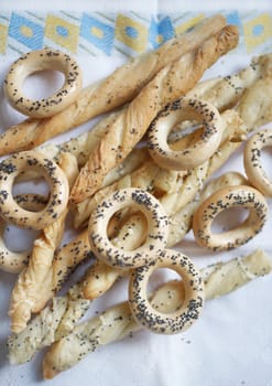 Cracknels and breadsticks on the tablecloth with pattern