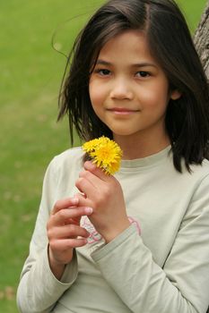 Girl holding freshly picked dandelions