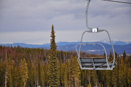 A chair lift is empty and not moving at a Colorado ski resort.