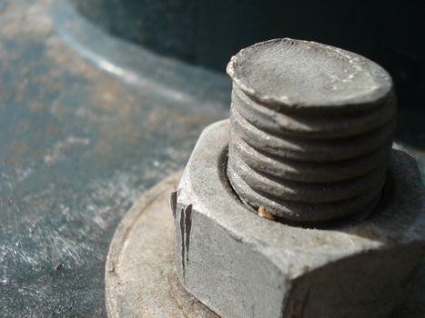 A nut is fastened securely to a screw.