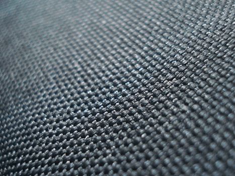 A shallow depth of field shot of black, textured fabric.