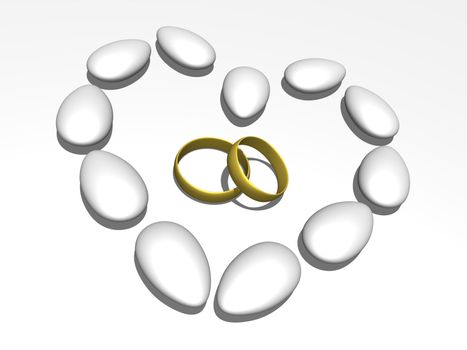 Wedding rings within a heart formed by sugared almonds