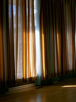 Warm filtered sunlight through classic curtains.