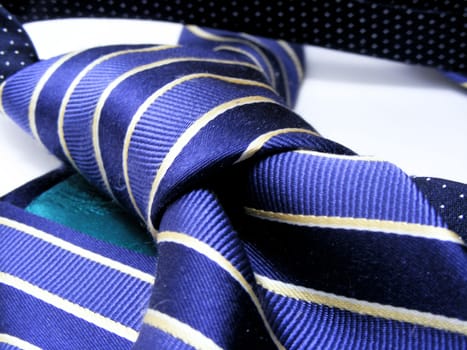 Striped designer silk tie on white background.