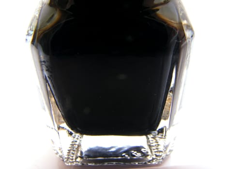 Black paint in clear glass container on white background.