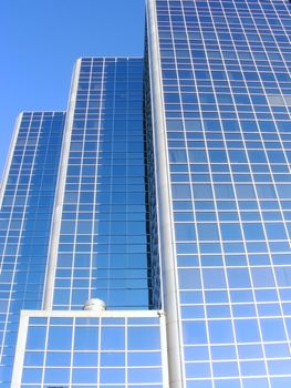 Blue sky reflected in modern office complex.