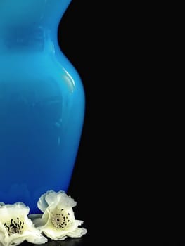 Curvacious, elegant blue vase with 2 petals at its base.