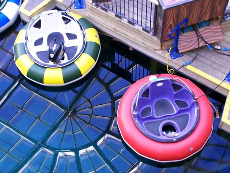 Bumper boats waiting for passangers at an indoor theme park.