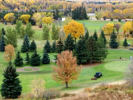 Grooming the river valley golf course near the end of the fall season.