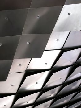 Metallic scales as part of a ceiling structure.