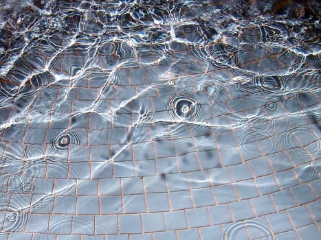 Waves and bubbles in a fountain pool.