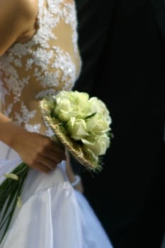 The bride holds a wedding bouquet. This image is made with the help a soft of an objective